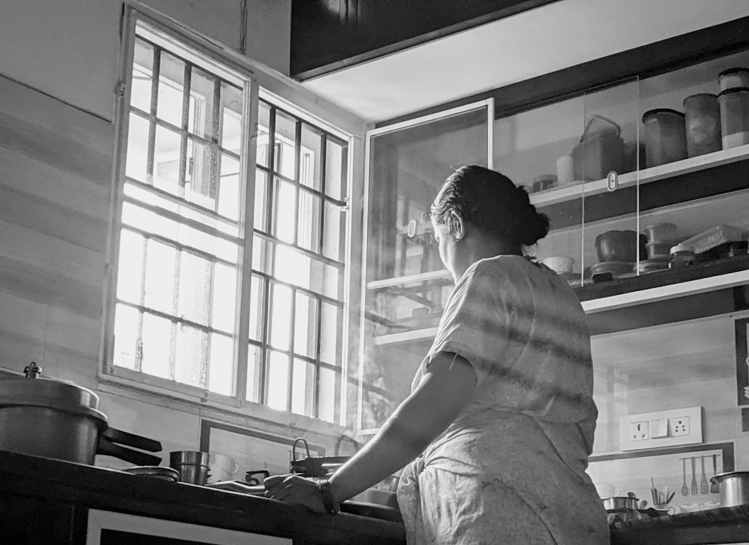 Domestic help preparing food in a home kitchen, maid service in Faridabad