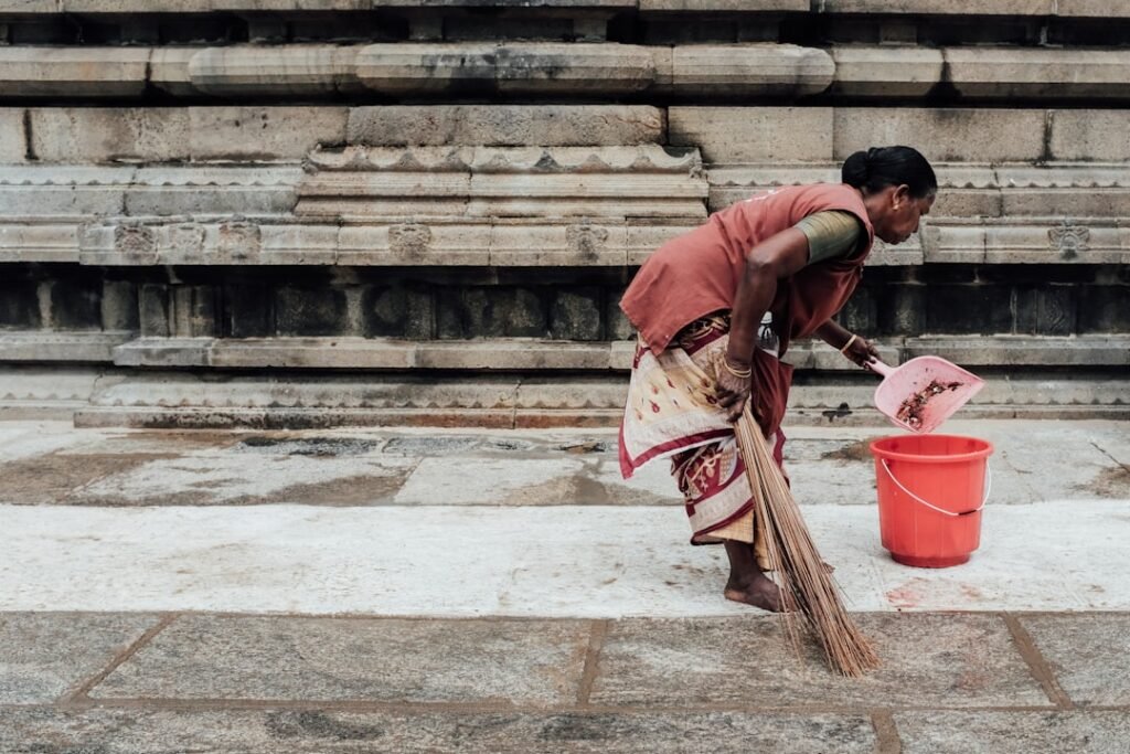 Trusted maid holding dustpan, hire a maid in Delhi guide